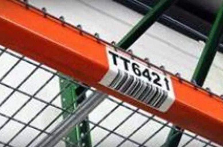 A close up of the tag on a warehouse rack