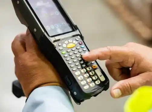 A person holding a cell phone in their hand.