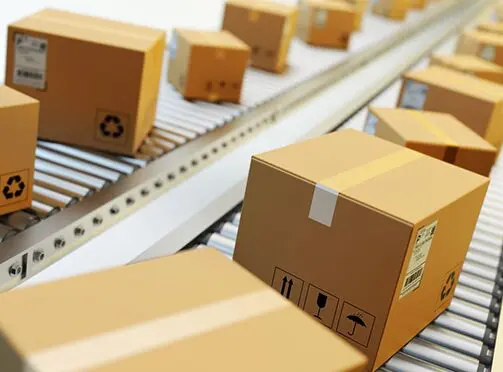 A conveyor belt with many boxes on it